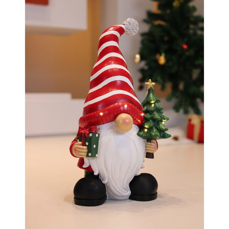 Santa Holding Christmas Tree